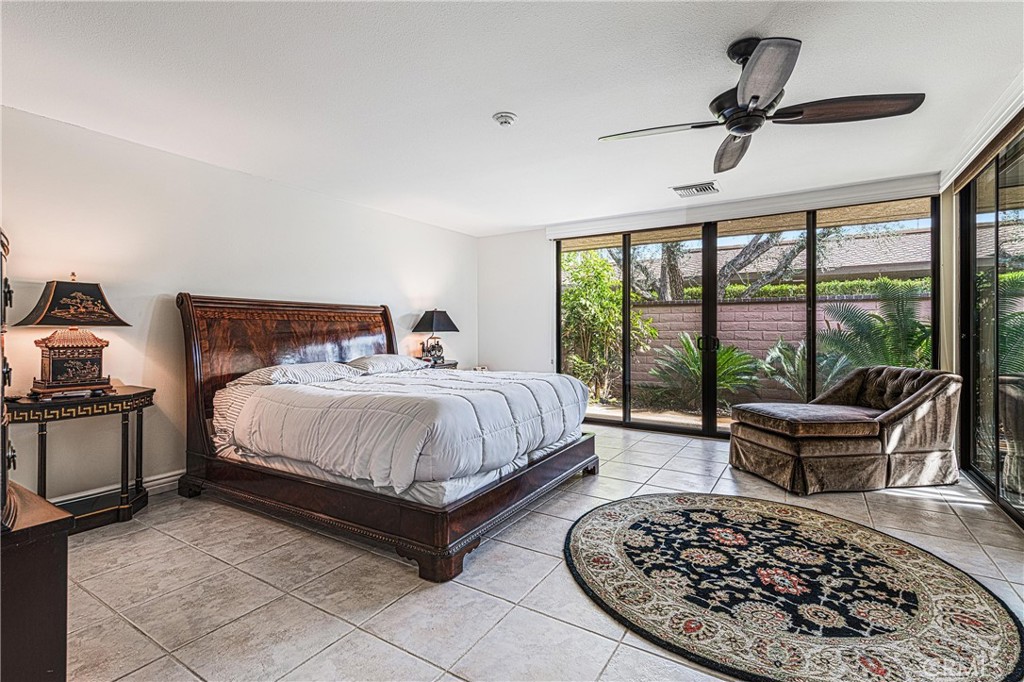 19 Cornell Drive Rancho Mirage, CA 92270 - Photo 13 of 22 a bed room with a bed and a chair