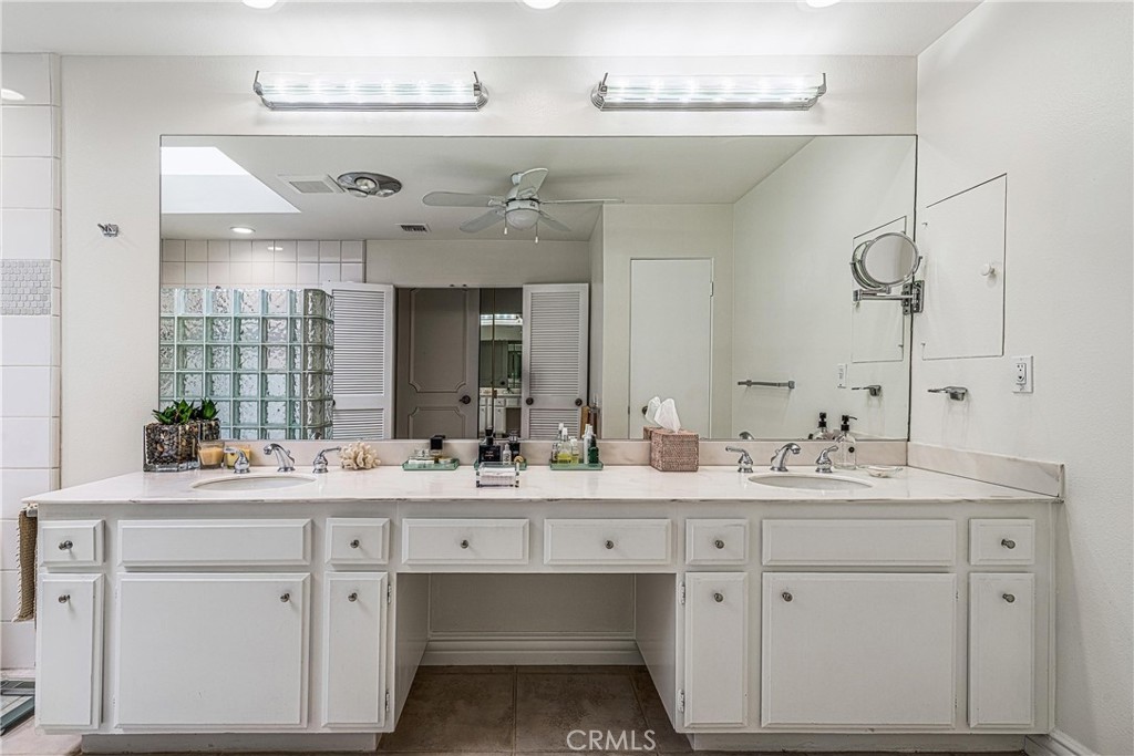 19 Cornell Drive Rancho Mirage, CA 92270 - Photo 16 of 22 a bathroom with a double vanity sink and a mirror