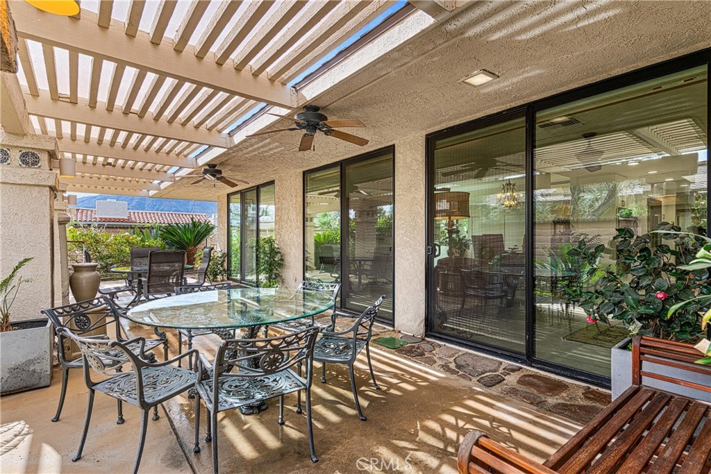 19 Cornell Drive Rancho Mirage, CA 92270 - Photo 20 of 22 a view of a patio with a table and chairs