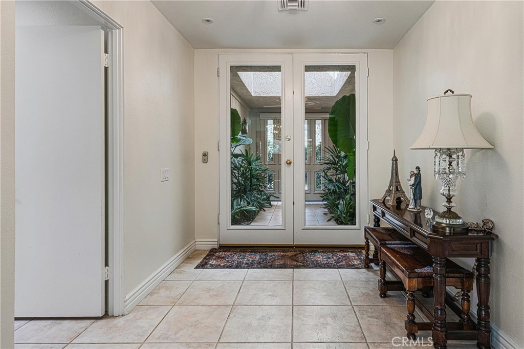 19 Cornell Drive Rancho Mirage, CA 92270 - Photo 3 of 22 a view of a room with gym equipment and a window