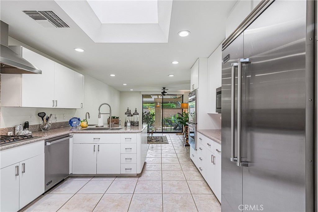 19 Cornell Drive Rancho Mirage, CA 92270 - Photo 9 of 22 a large kitchen with stainless steel appliances lots of counter space sink and a mirror
