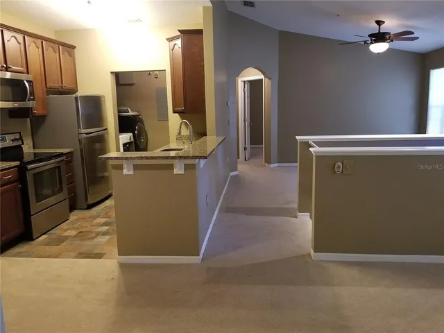 a kitchen with refrigerator and microwave