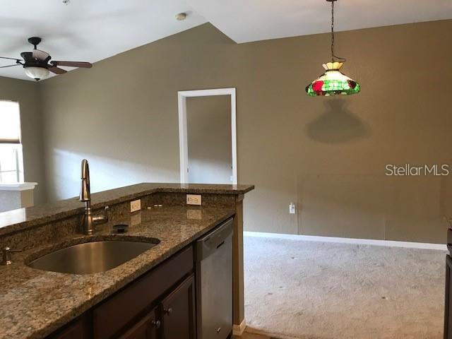 835 Grand Regency Pointe, Unit 205 Altamonte Springs, FL 32714 - Photo 6 of 18 a kitchen with a sink and chandelier