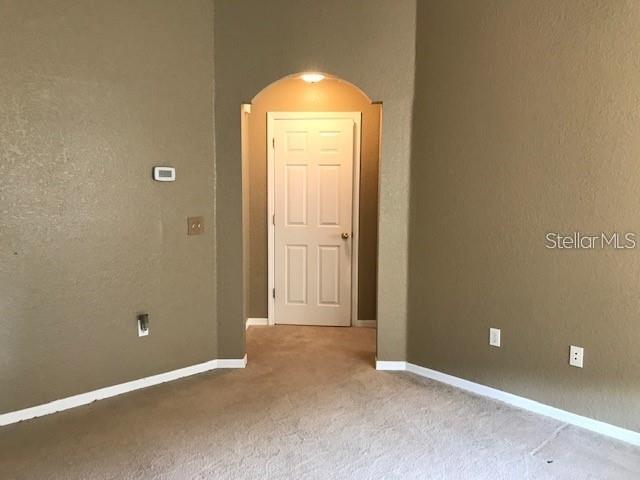 835 Grand Regency Pointe, Unit 205 Altamonte Springs, FL 32714 - Photo 9 of 18 an empty room with windows and closet
