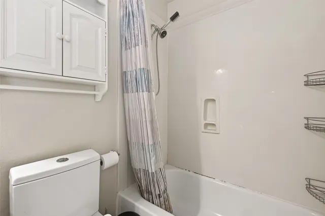 a bathroom with a bathtub and toilet