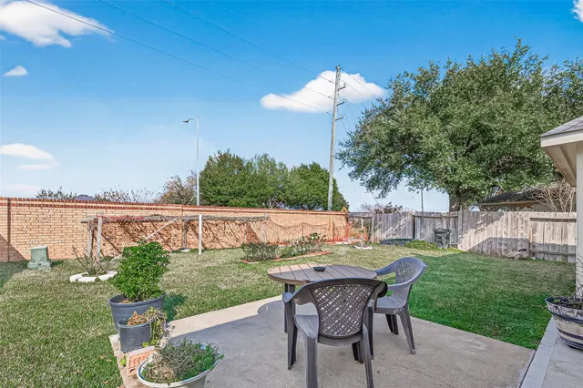 a view of a table and chairs in patio yard