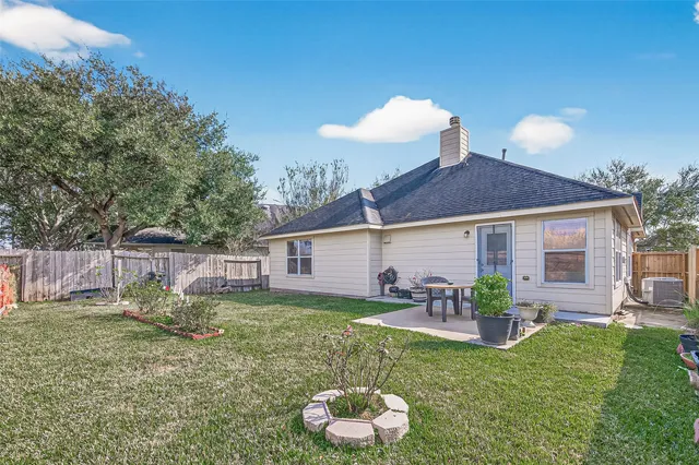 a view of a house with a yard and a garden