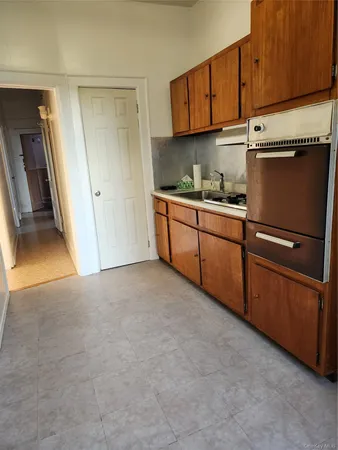 a kitchen with granite countertop a sink and cabinets