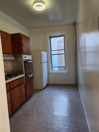 a view of a kitchen with refrigerator and cabinet