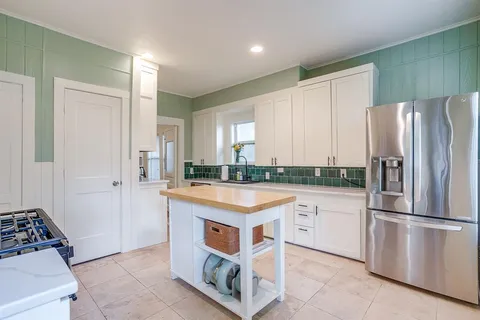 a kitchen with stainless steel appliances granite countertop a refrigerator and a stove