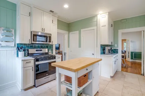 a kitchen with stainless steel appliances granite countertop a stove oven and a refrigerator