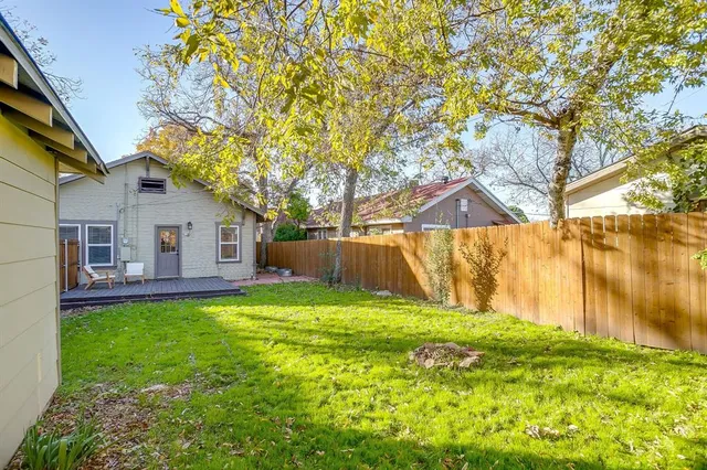 a backyard of a house with table and chairs