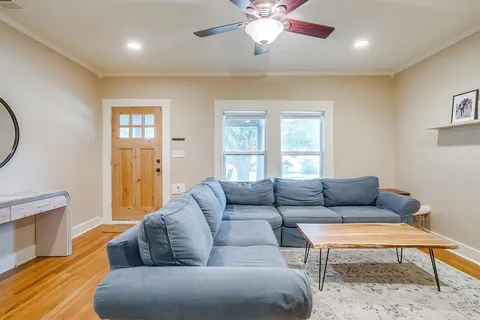 a living room with furniture a rug and a window