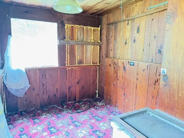 a view of small space with wooden floor and chair