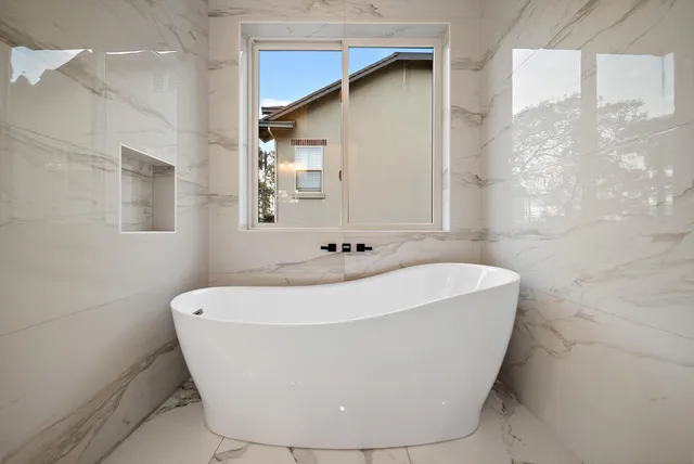 a white bath tub sitting in a bathroom