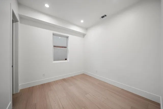 a view of a room with wooden floor and windows