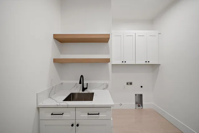 a room with a sink and cabinets