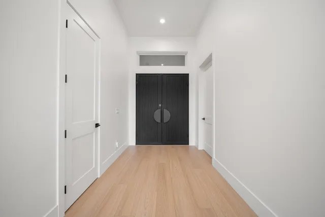 a view of a hallway with wooden floor