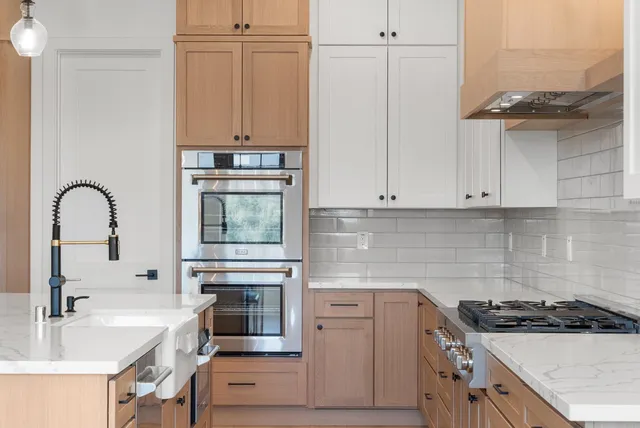 a kitchen with granite countertop a stove and a sink