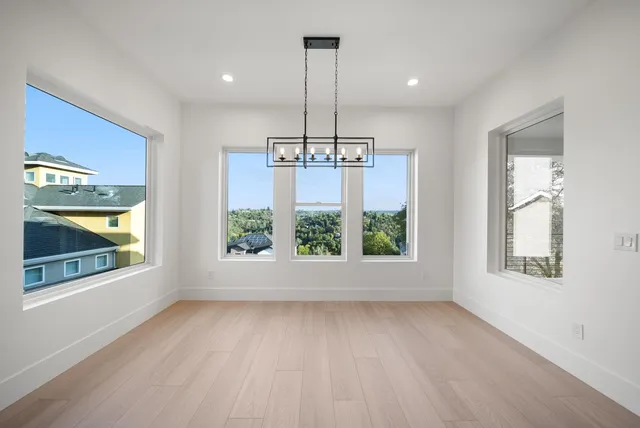 an empty room with windows and outdoor view