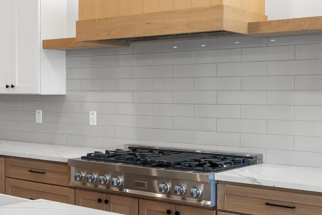 a stove top oven sitting inside of a kitchen