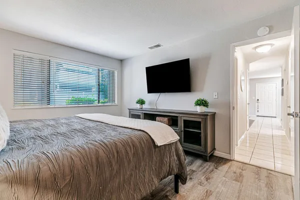 a bedroom with a bed and a flat screen tv