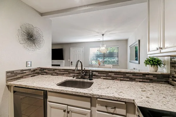 a kitchen with a sink and a white cabinets