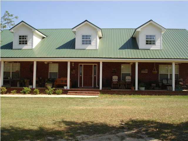 5127 Keyser Mill Road Baker, FL 32531 - Photo 2 of 13 a front view of a house with swimming pool and porch