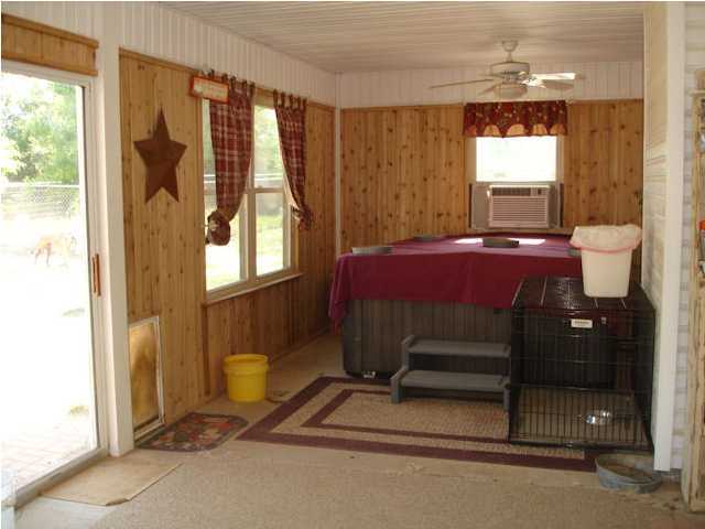 5127 Keyser Mill Road Baker, FL 32531 - Photo 11 of 13 a bedroom with a bed and a window