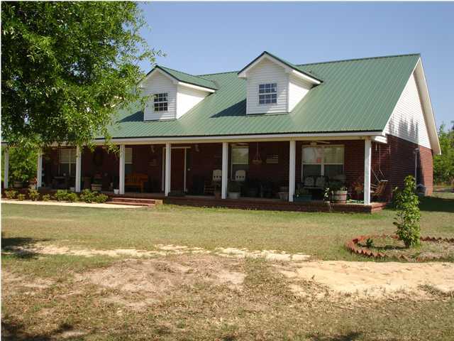 5127 Keyser Mill Road Baker, FL 32531 - Photo 3 of 13 a front view of a house with a yard and garage