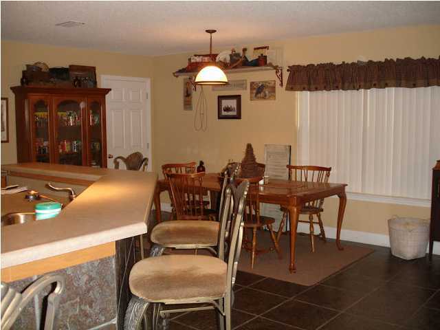 5127 Keyser Mill Road Baker, FL 32531 - Photo 9 of 13 a view of a dining room with furniture and wooden floor