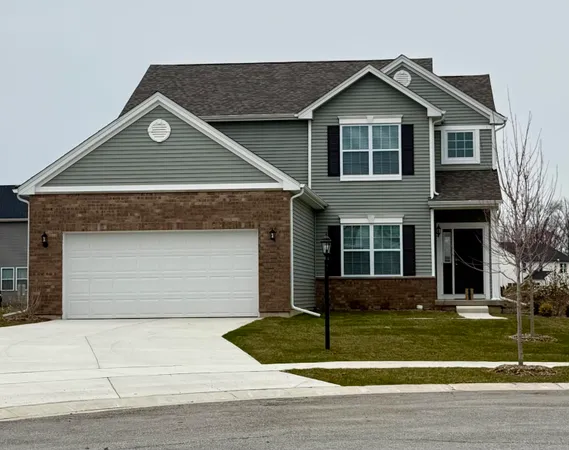 a front view of a house with a yard garage and garage