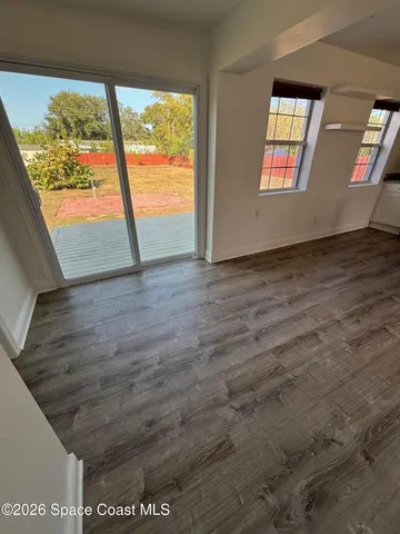 an empty room with windows and entrance