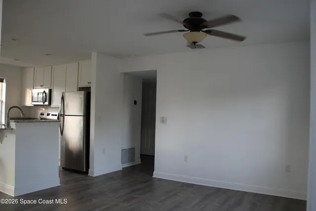 a kitchen with stainless steel appliances a stove top oven a sink dishwasher and a refrigerator