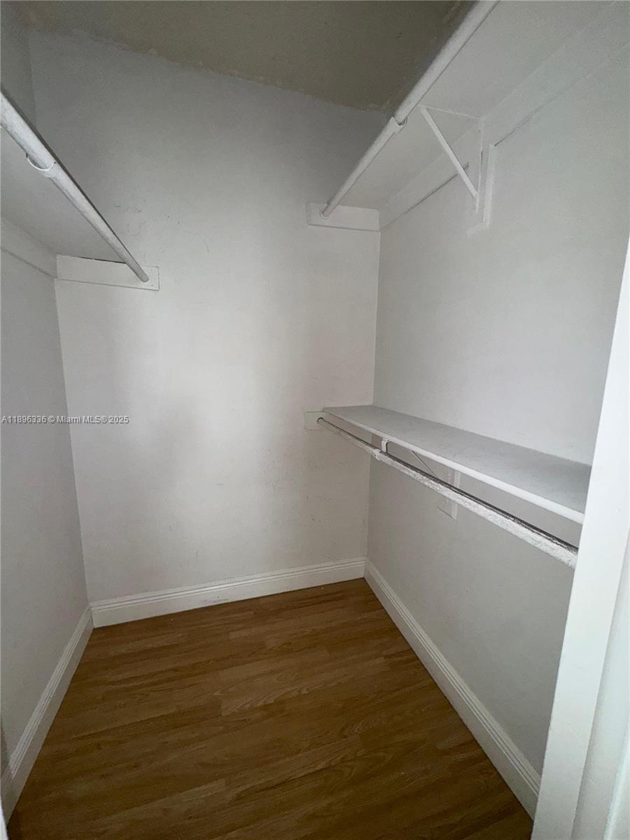 6095 West 19th Avenue, Unit 407 Hialeah, FL 33012 - Photo 8 of 10 a view of a room with wooden floor