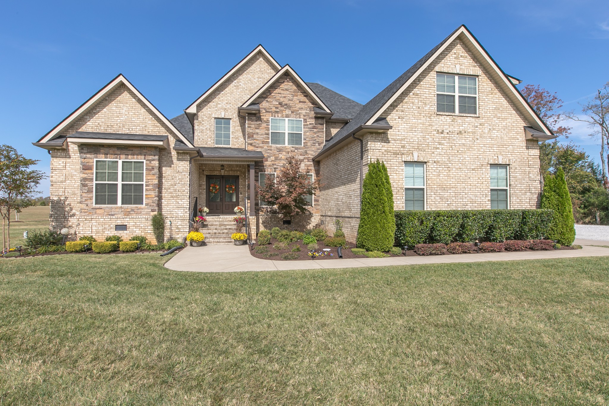 8478 Newtown Road Rockvale, TN 37153 - Photo 1 of 54 a view of a brick house with a yard and large trees