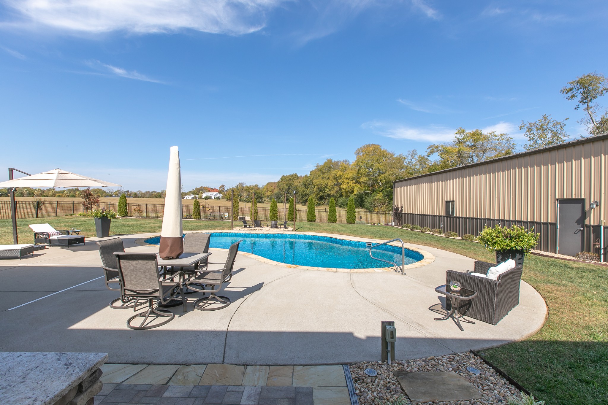 8478 Newtown Road Rockvale, TN 37153 - Photo 12 of 54 a view of a swimming pool with outdoor seating and plants