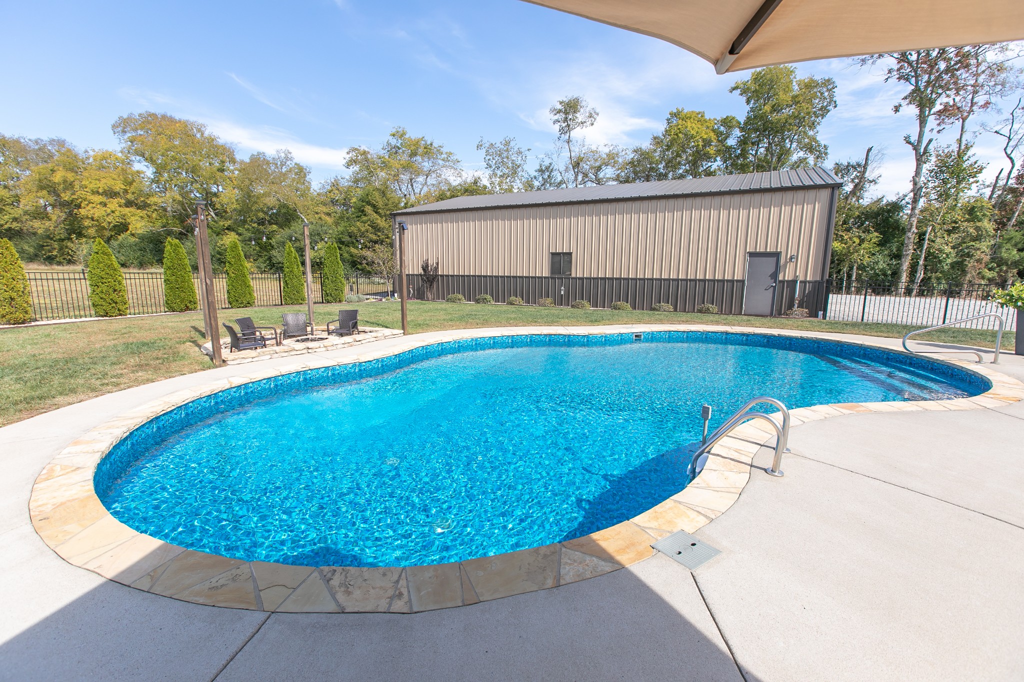 8478 Newtown Road Rockvale, TN 37153 - Photo 18 of 54 a view of a swimming pool with a patio