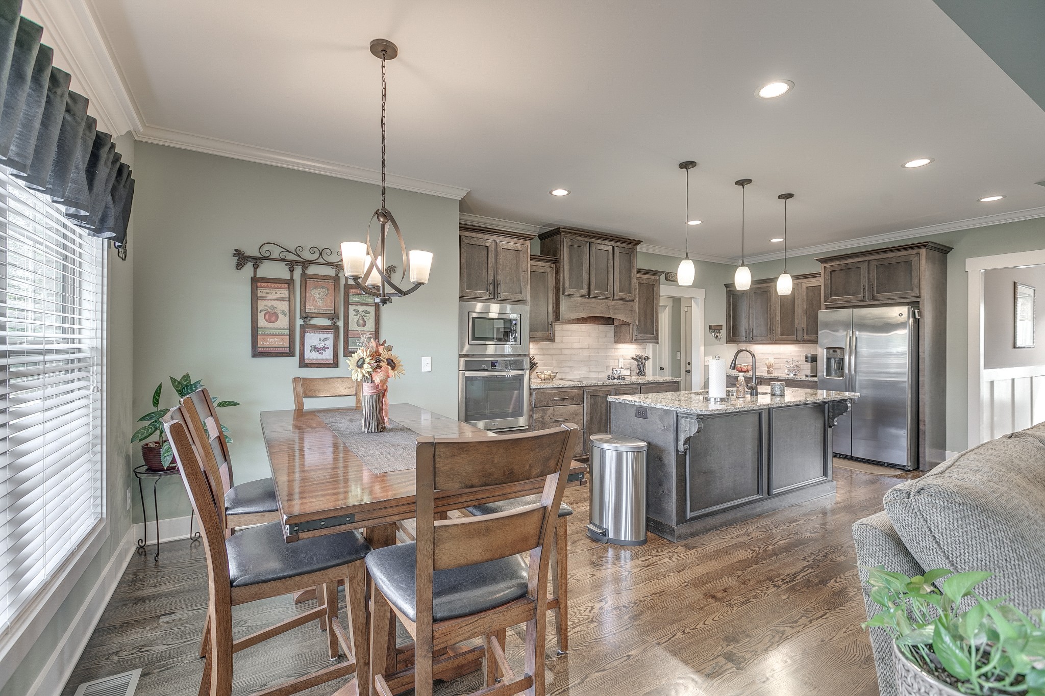 8478 Newtown Road Rockvale, TN 37153 - Photo 30 of 54 a view of a dining room and livingroom with furniture wooden floor kitchen chandelier