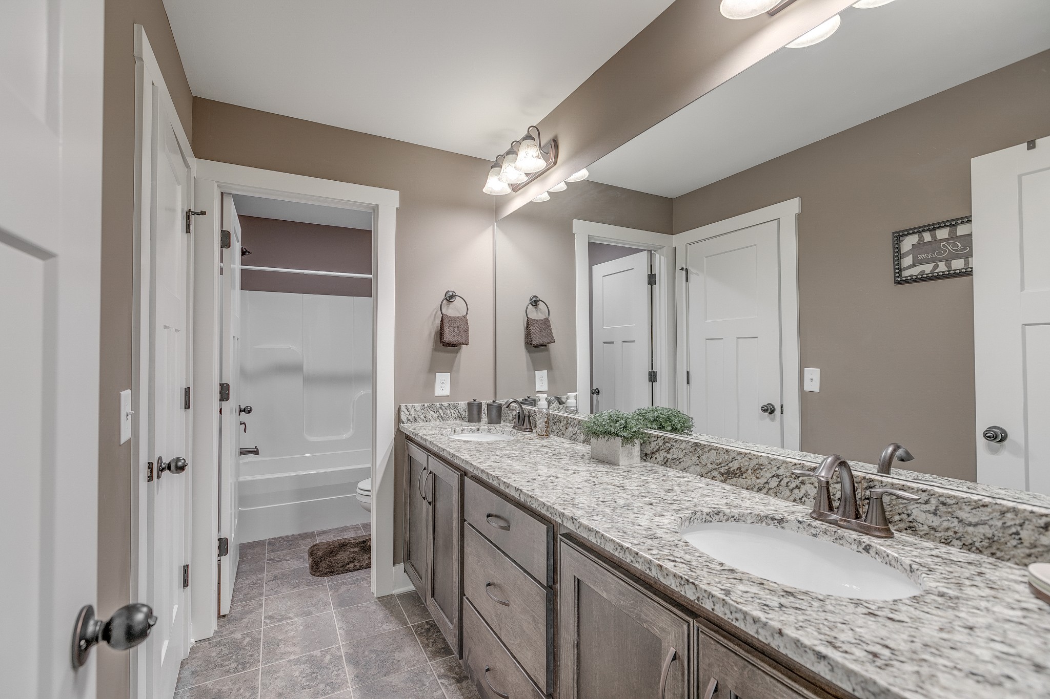 8478 Newtown Road Rockvale, TN 37153 - Photo 47 of 54 a bathroom with a granite countertop sink double vanity and a mirror