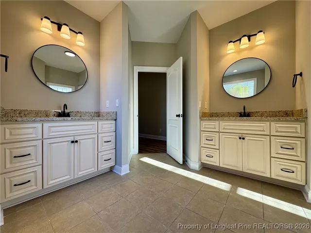 a bathroom with a double vanity sink and a mirror