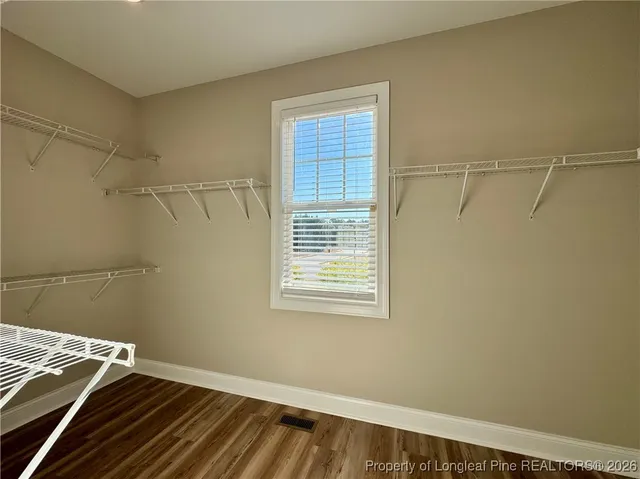 a view of a room with rack on the wall and a window
