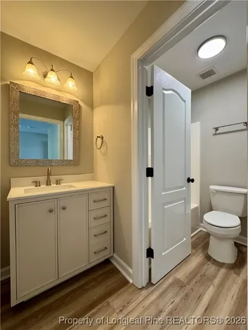 a spacious bathroom with a double vanity sink mirror and toilet
