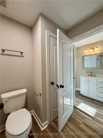 a white toilet sitting next to a bathroom sink