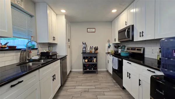 a kitchen with cabinets and appliances
