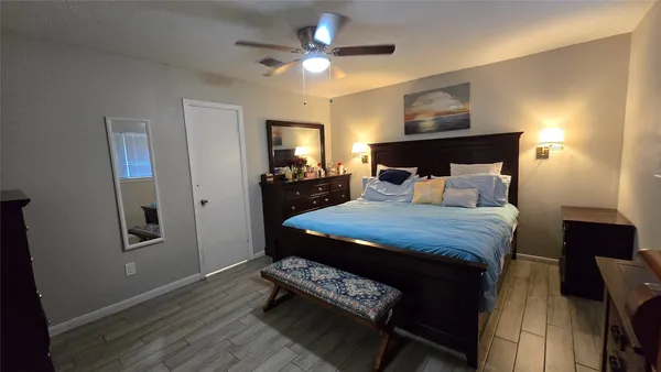 a bedroom with a bed and a chandelier