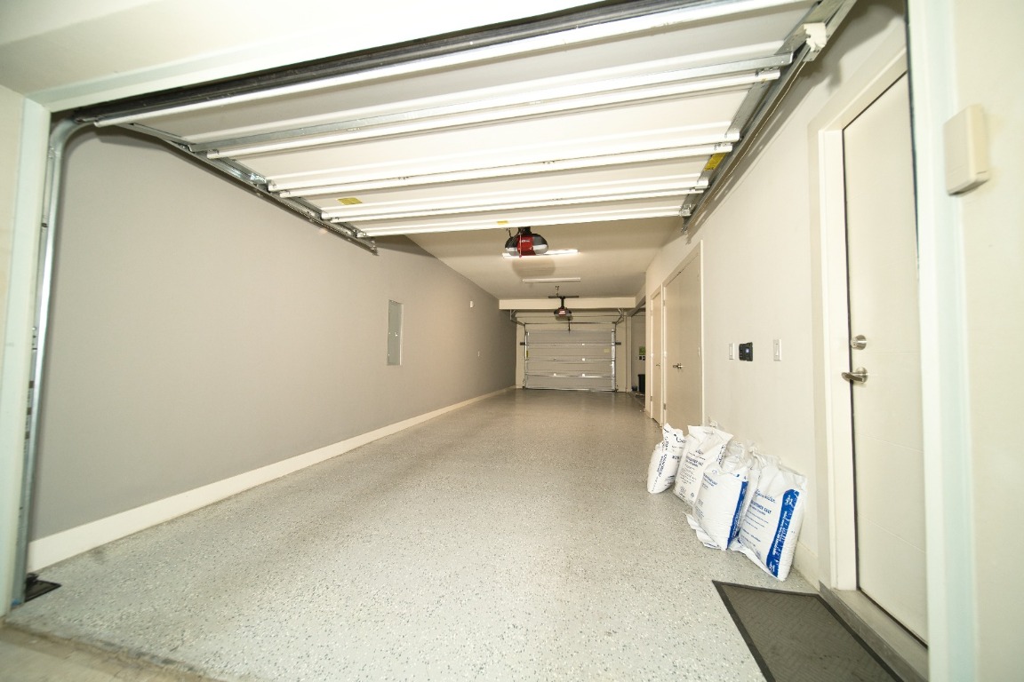 604 North Bluff Drive, Unit 247 Austin, TX 78745 - Photo 22 of 23 Garage with a garage door opener and electric panel
