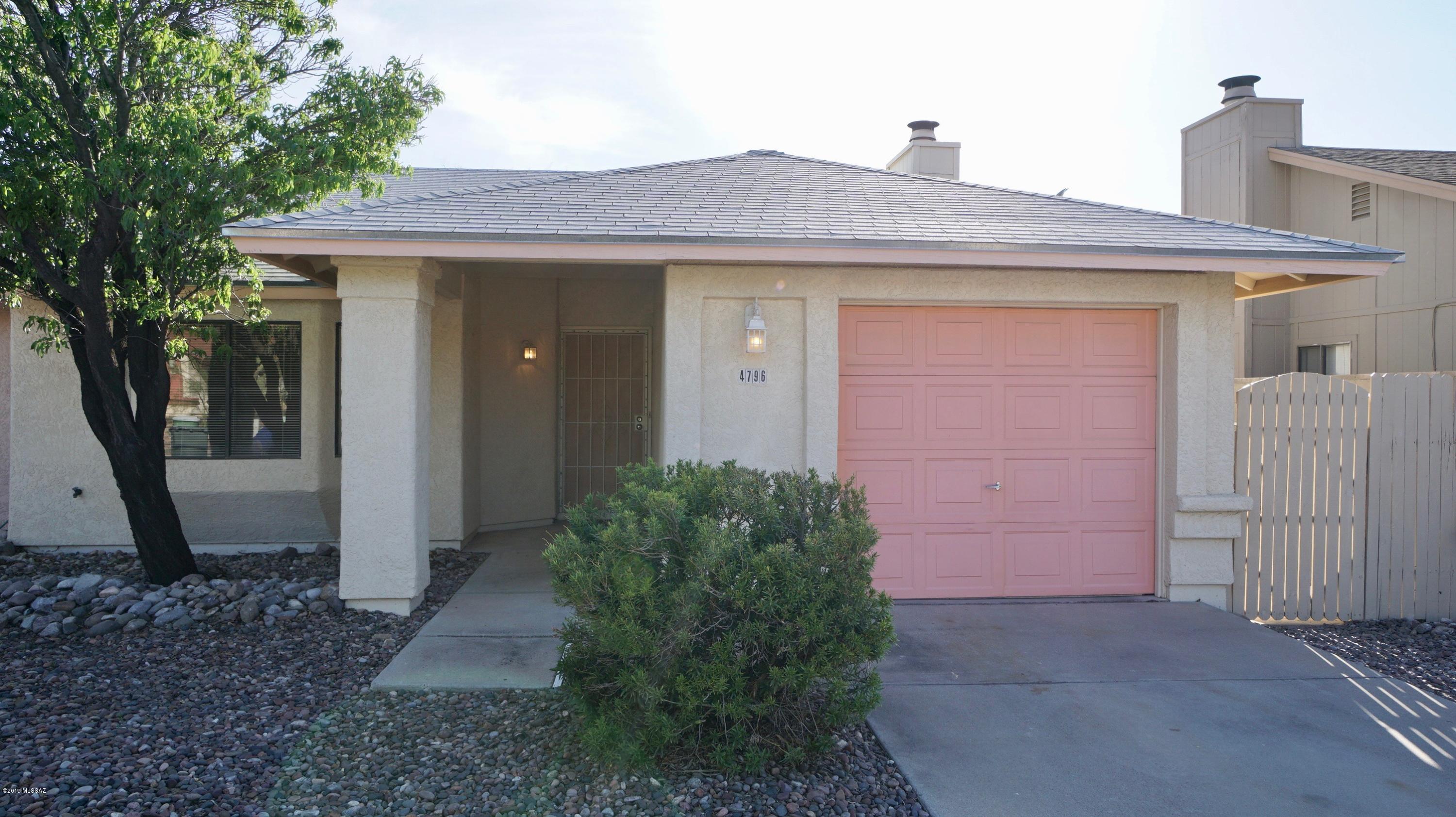 4796 South Lincoln Ridge Drive Tucson, AZ 85730 - Photo 1 of 12 a front view of a house with garden