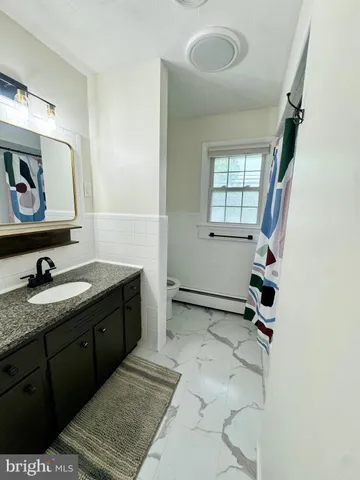 a room with a sink and a mirror