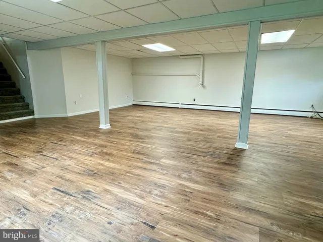 a view of a room with wooden floor